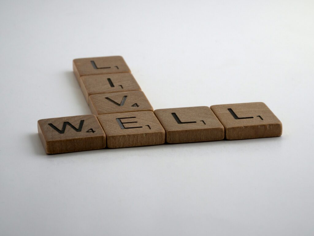 Scrabble tiles spelling 'Live Well'- representing a healthy lifestyle,personalized diet plan and wellness approach.